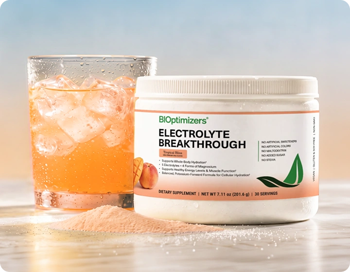 Glass of orange electrolyte drink with BIOptimizers Electrolyte Breakthrough