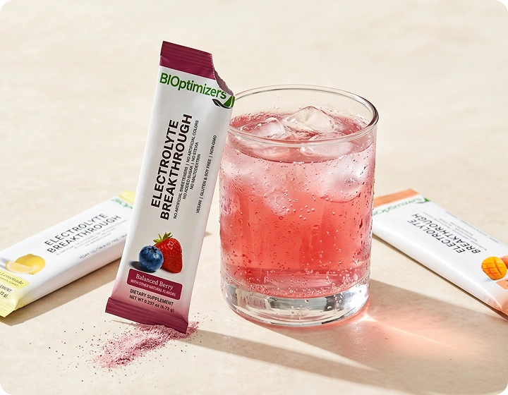 Glass of pink electrolyte drink with BIOptimizers Electrolyte Breakthrough