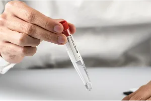 Close-up of a powdered supplement being stirred into clear water in a glass, illustrating health supplements, hydration, dietary support, and wellness routine
