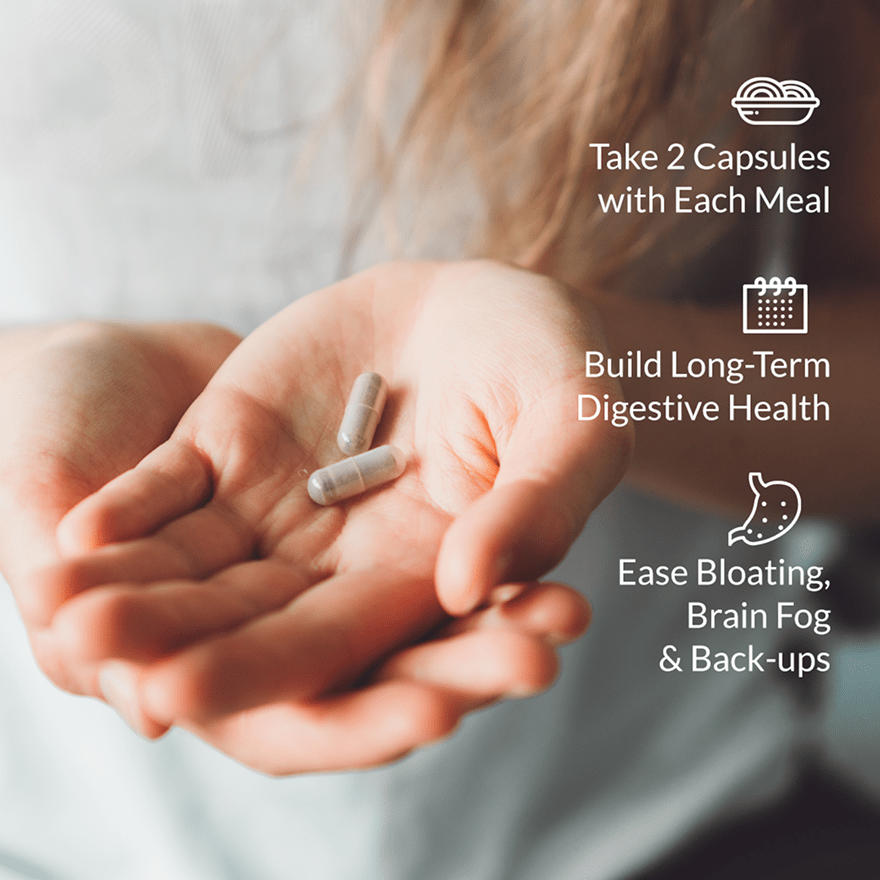 a woman holds a handful of probiotic breakthrough capsules
