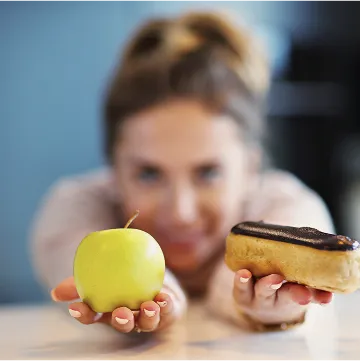 a woman holds an apple
