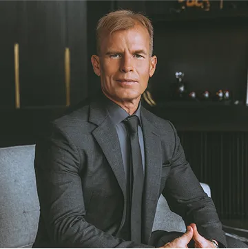 person holding a slice of cheese pizza