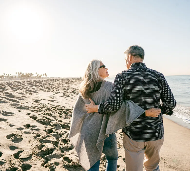couple-walking-on-beach.webp